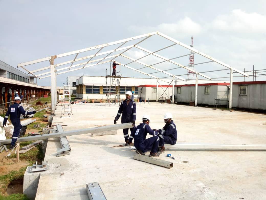 Davtrebs Empire workers installing tent frame on site